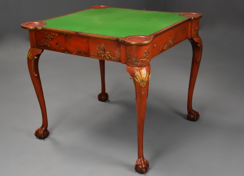 An early twentieth-century red lacquered games table with gilded Chinoiserie designs, cabriole legs, and ball and claw feet. View XI