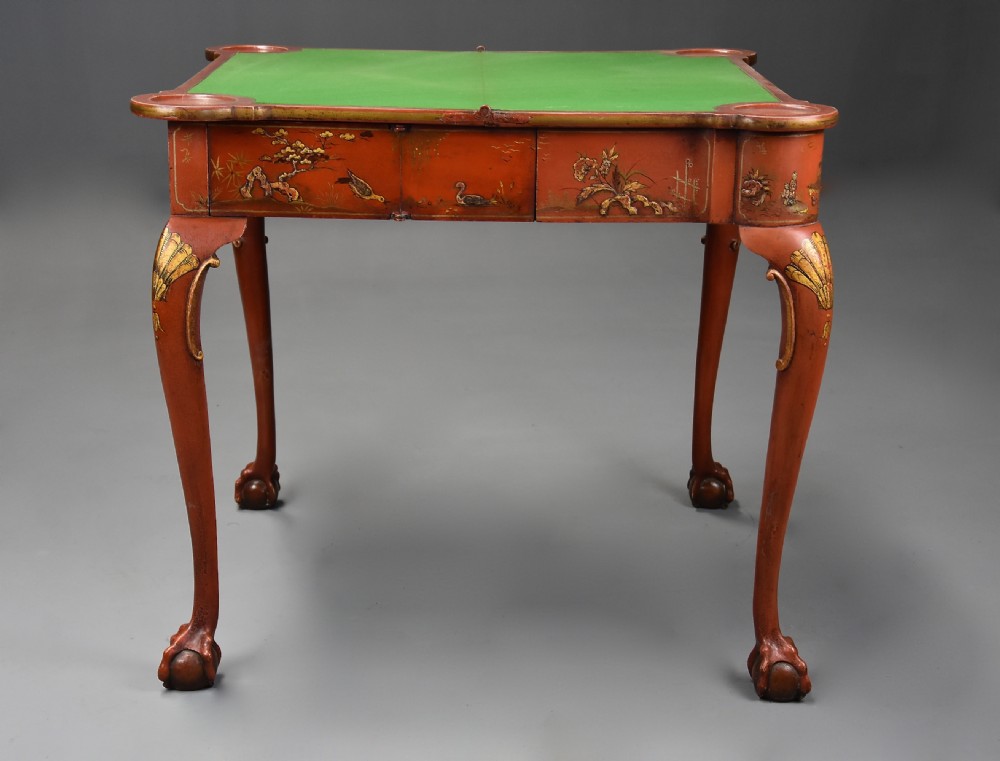 An early twentieth-century red lacquered games table with gilded Chinoiserie designs, cabriole legs, and ball and claw feet. View XIII