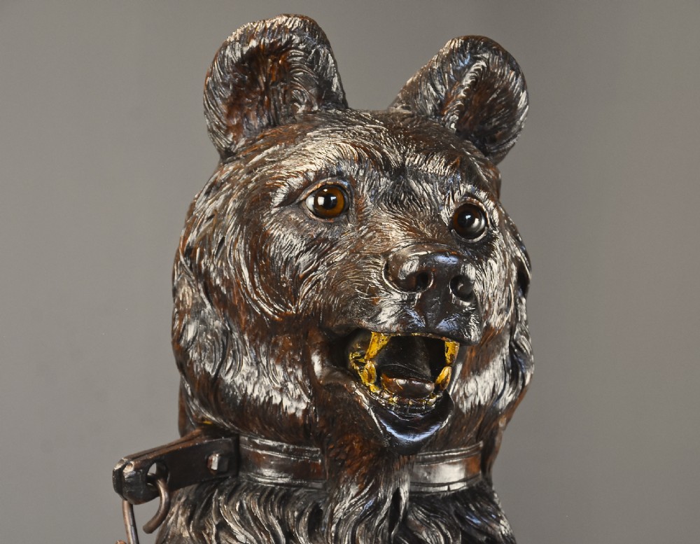A late 19th-century carved wood Black Forest hall stand depicting an upright bear on a carved rockwork base with an integrated metal drip tray. View V