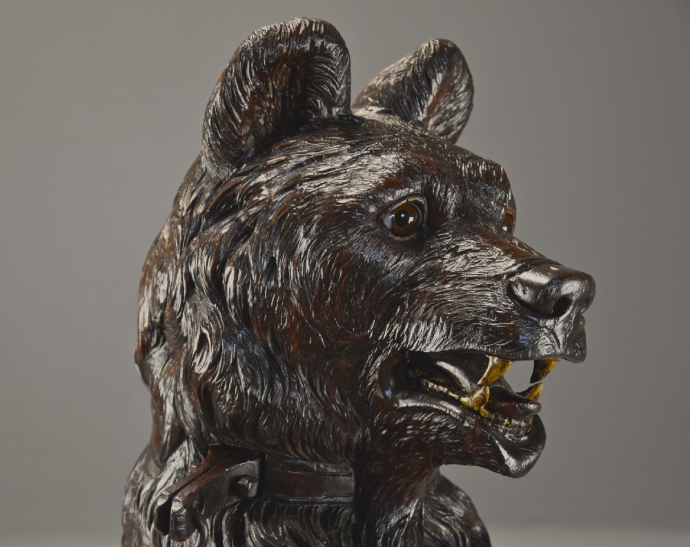 A late 19th-century carved wood Black Forest hall stand depicting an upright bear on a carved rockwork base with an integrated metal drip tray. View XI