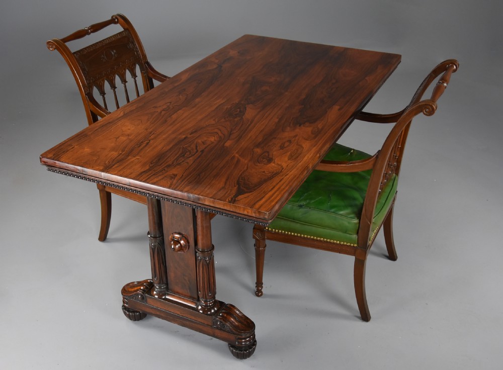 A William IV rosewood centre writing table featuring a rectangular top, beaded border, carved end supports, a central turned stretcher, and lobed feet. View VII
