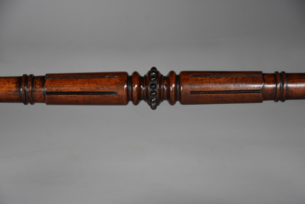 A William IV rosewood centre writing table featuring a rectangular top, beaded border, carved end supports, a central turned stretcher, and lobed feet. View XIII
