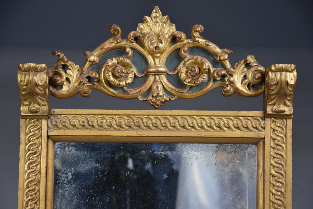 A late nineteenth-century Renaissance Revival carved giltwood table mirror featuring a scrolled cresting, guilloche moulding, and paw feet. View IX