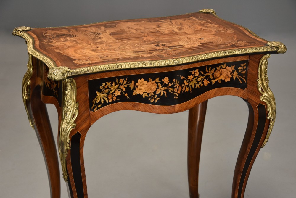 A mid-19th century French style kingwood centre table featuring detailed floral marquetry, curved cabriole legs, and polished ormolu mounts. View IV