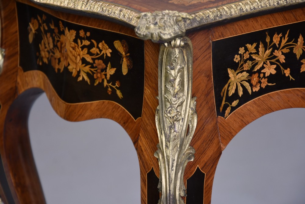 A mid-19th century French style kingwood centre table featuring detailed floral marquetry, curved cabriole legs, and polished ormolu mounts. View IX