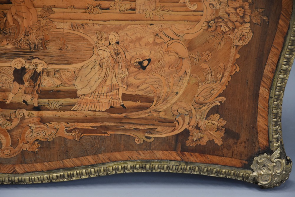 A mid-19th century French style kingwood centre table featuring detailed floral marquetry, curved cabriole legs, and polished ormolu mounts. View XVI