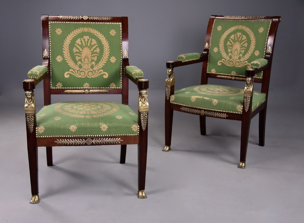 Pair of late 19th-century French Empire style mahogany open armchairs upholstered in green patterned fabric with brass mounts and paw feet. View II