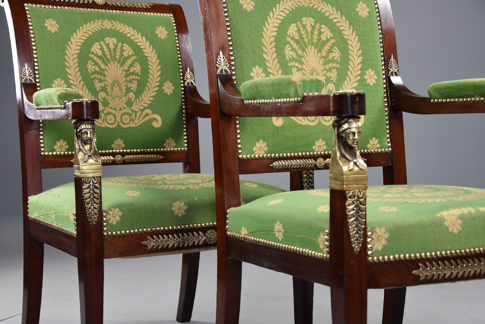 Pair of late 19th-century French Empire style mahogany open armchairs upholstered in green patterned fabric with brass mounts and paw feet. View V