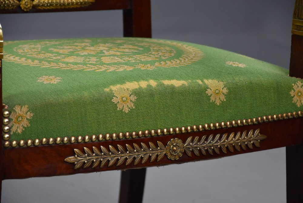 Pair of late 19th-century French Empire style mahogany open armchairs upholstered in green patterned fabric with brass mounts and paw feet. View IX