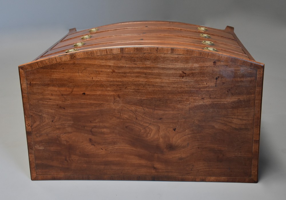 A late eighteenth-century mahogany bow-front chest of drawers featuring four graduated drawers with circular brass handles and splayed bracket feet. View VIII