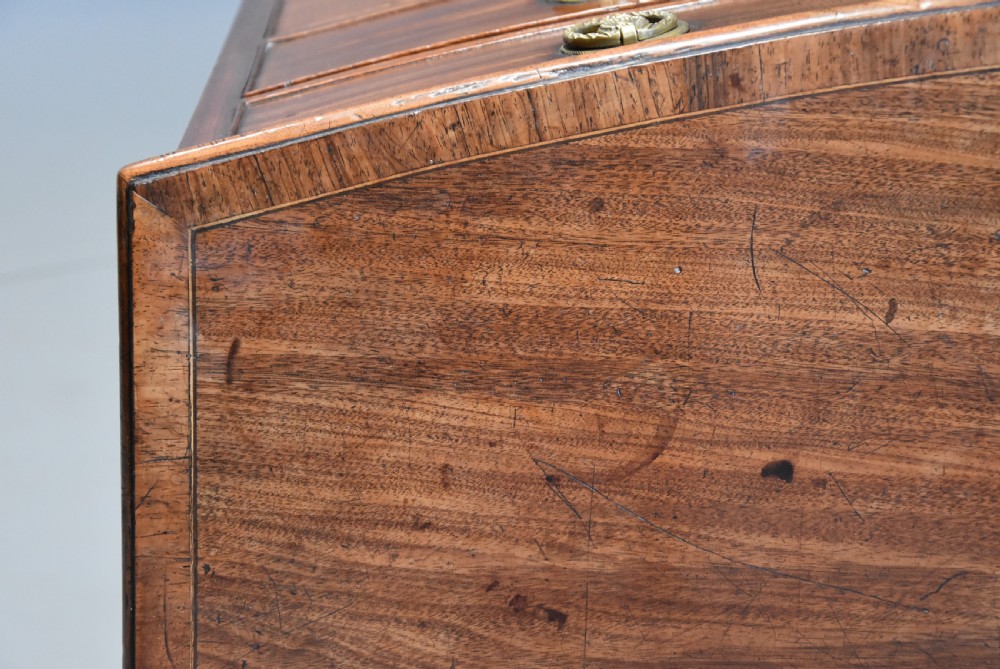 A late eighteenth-century mahogany bow-front chest of drawers featuring four graduated drawers with circular brass handles and splayed bracket feet. View IX