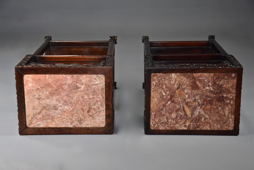 A matched pair of late nineteenth-century Chinese dark hardwood plant stands featuring inset marble tops, carved openwork aprons, and two lower tiers. View XI