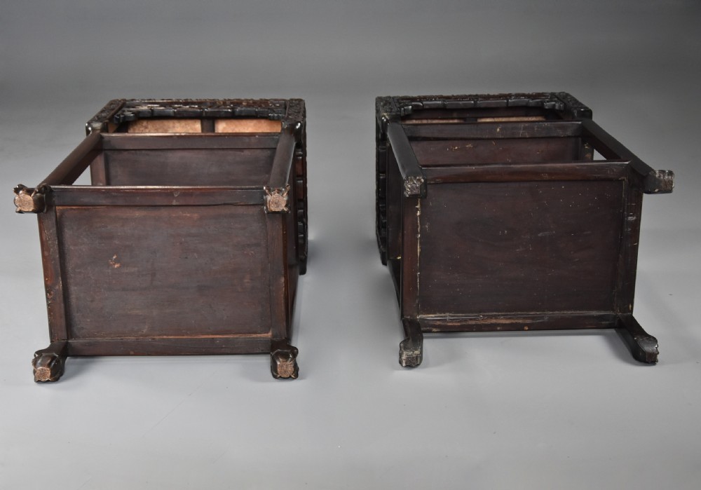 A matched pair of late nineteenth-century Chinese dark hardwood plant stands featuring inset marble tops, carved openwork aprons, and two lower tiers. View XII