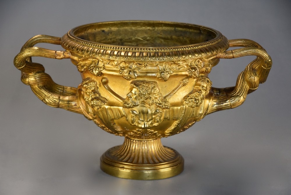 A 19th-century gilt bronze reduction of the Warwick Vase featuring high-relief Bacchic masks, intertwined vine handles, and a pedestal base. View II