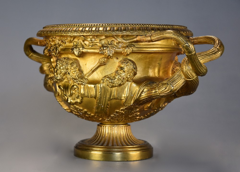 A 19th-century gilt bronze reduction of the Warwick Vase featuring high-relief Bacchic masks, intertwined vine handles, and a pedestal base. View VIII