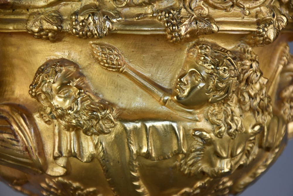 A 19th-century gilt bronze reduction of the Warwick Vase featuring high-relief Bacchic masks, intertwined vine handles, and a pedestal base. View X