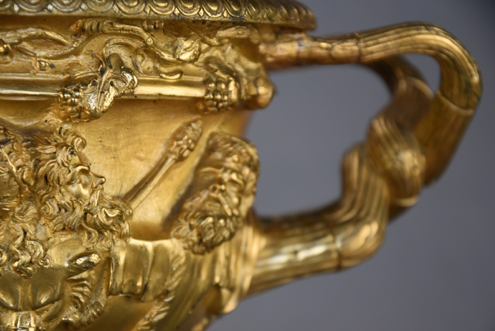 A 19th-century gilt bronze reduction of the Warwick Vase featuring high-relief Bacchic masks, intertwined vine handles, and a pedestal base. View XI