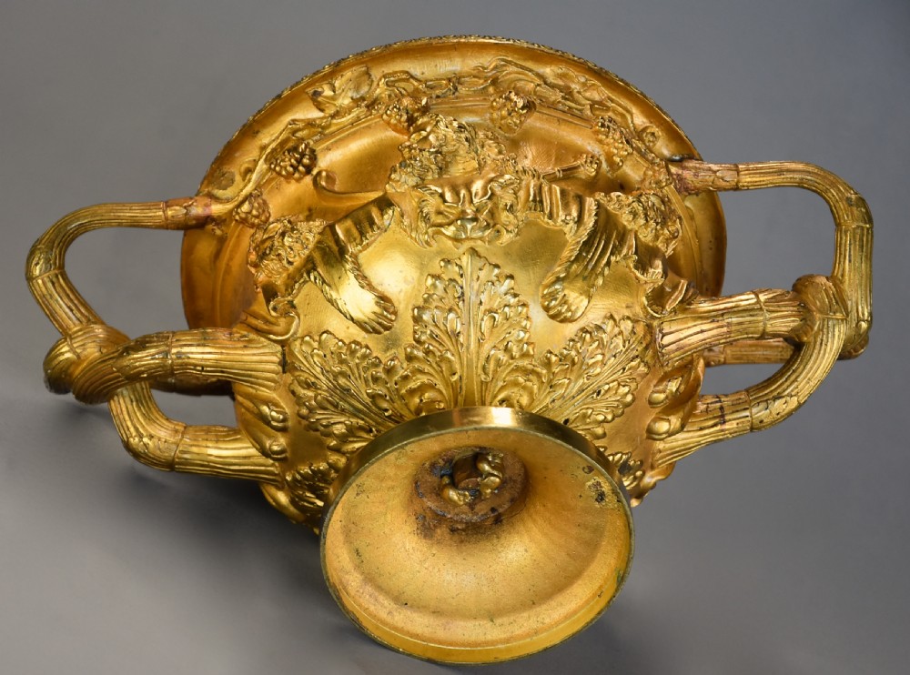 A 19th-century gilt bronze reduction of the Warwick Vase featuring high-relief Bacchic masks, intertwined vine handles, and a pedestal base. View XIV