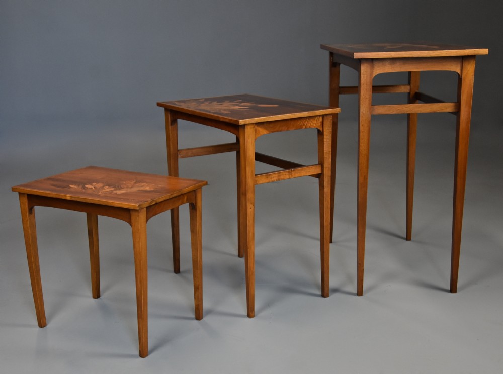 A set of three graduating French Art Nouveau rosewood nesting tables with floral marquetry tops and slender tapered legs. View III