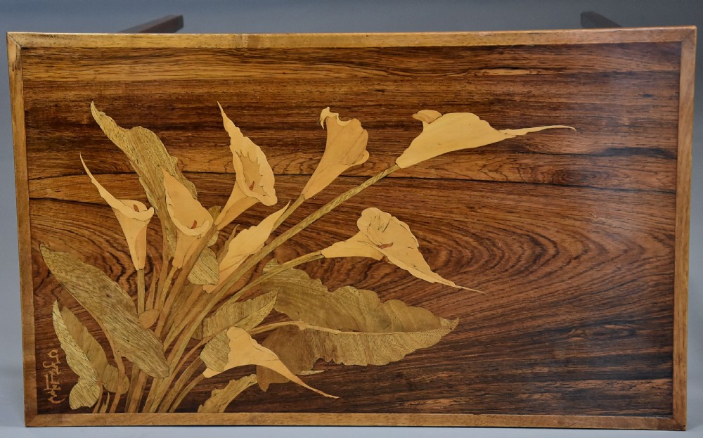 A set of three graduating French Art Nouveau rosewood nesting tables with floral marquetry tops and slender tapered legs. View VII