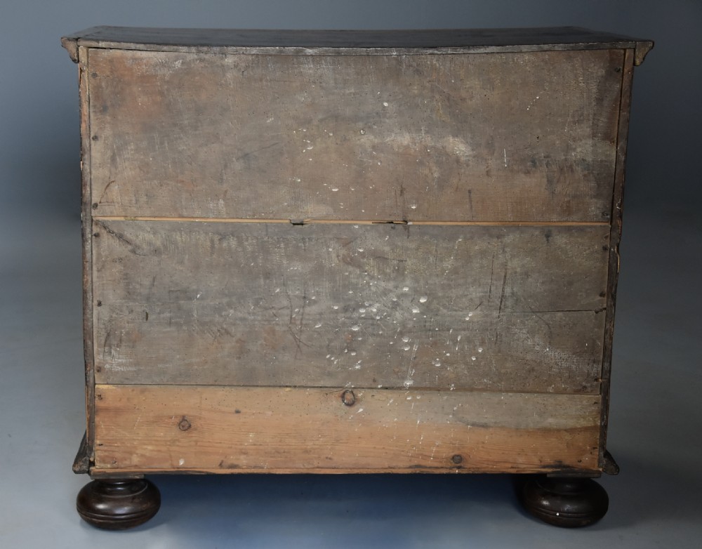 A late 17th-century William and Mary chest of drawers with oval yew wood veneers, brass teardrop handles, and dark turned bun feet. View XV