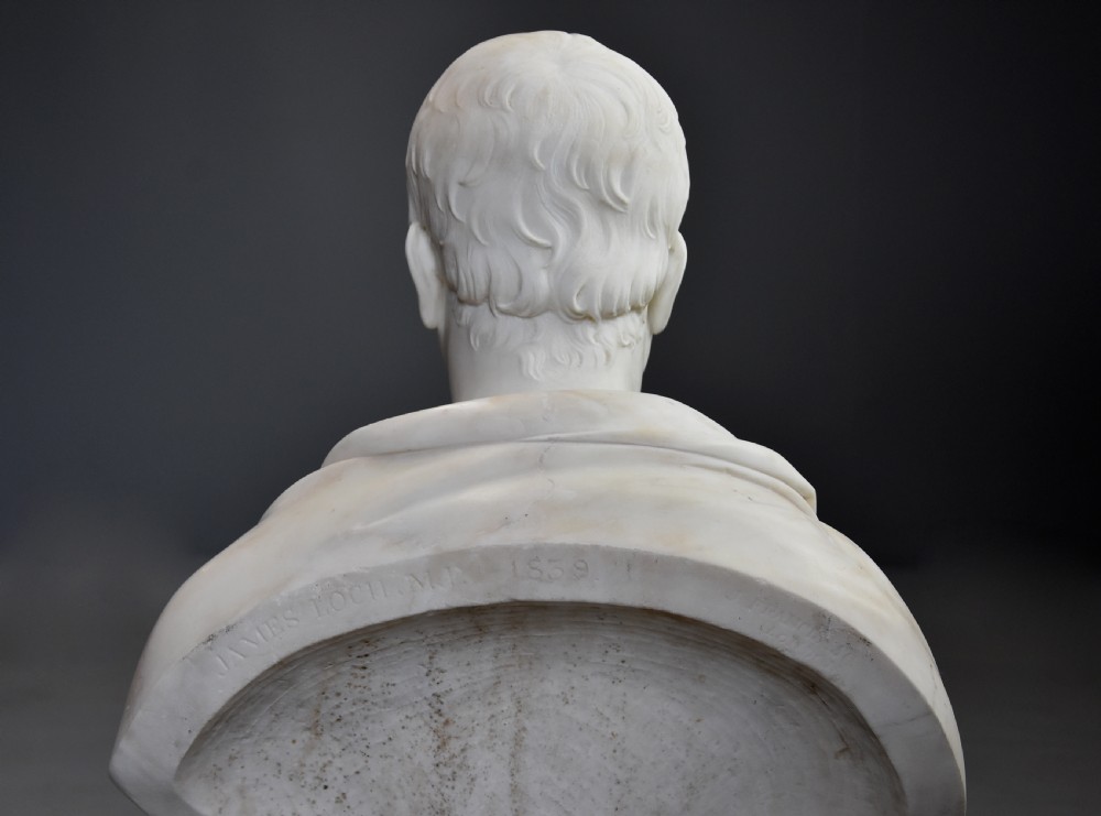 A carved white marble portrait bust of a gentleman wearing classical drapery mounted on a circular socle base. View XI