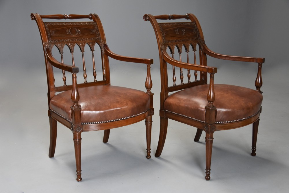 A pair of late 18th-century French Directoire style carved walnut open armchairs with studded brown leather seats. View III