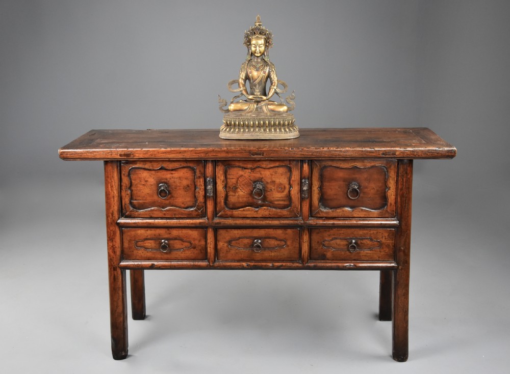 A late nineteenth-century rustic Chinese elm sideboard featuring three upper doors with contoured panels and three lower drawers fitted with metal ring pulls. View II