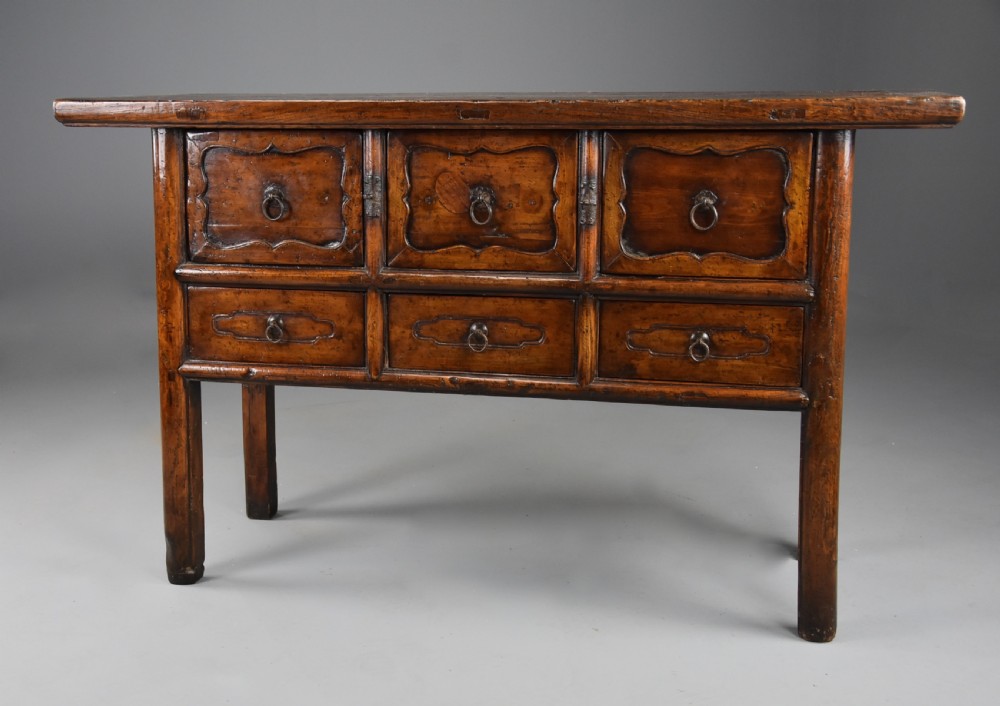 A late nineteenth-century rustic Chinese elm sideboard featuring three upper doors with contoured panels and three lower drawers fitted with metal ring pulls. View III