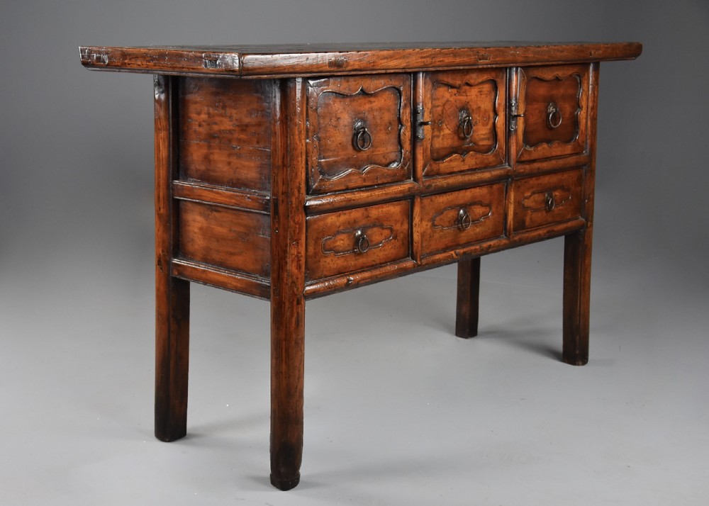 A late nineteenth-century rustic Chinese elm sideboard featuring three upper doors with contoured panels and three lower drawers fitted with metal ring pulls. View IV
