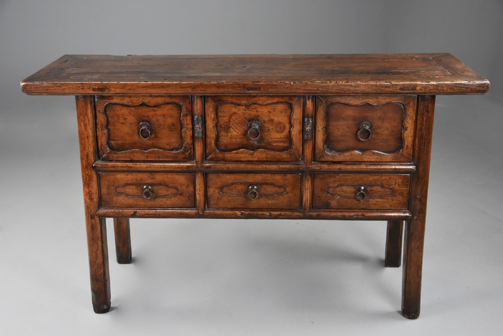 A late nineteenth-century rustic Chinese elm sideboard featuring three upper doors with contoured panels and three lower drawers fitted with metal ring pulls. View V