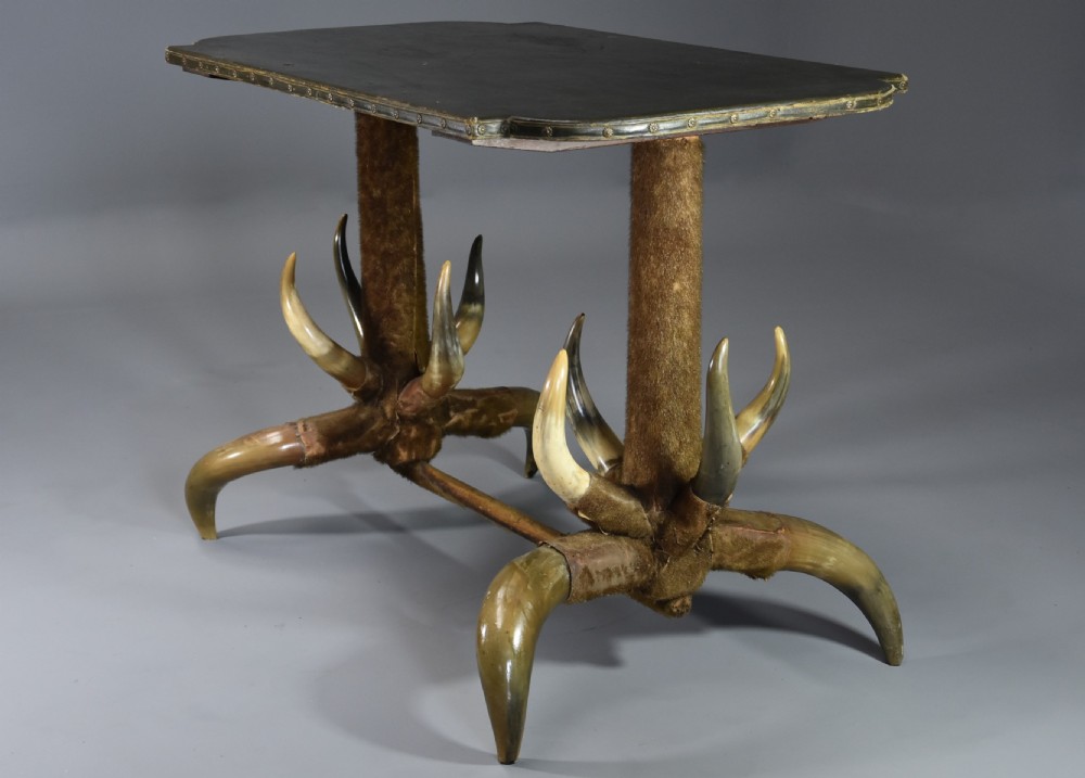 Late nineteenth-century German side table featuring a dark green leather studded top supported by fur-wrapped posts and natural cow horn legs. View IV
