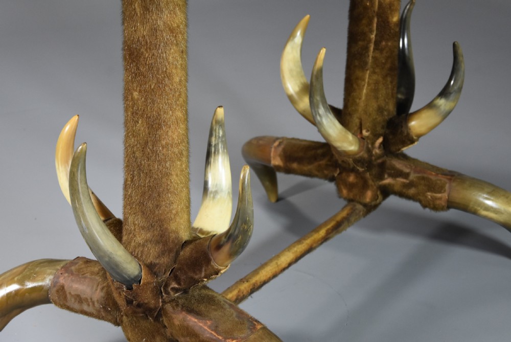 Late nineteenth-century German side table featuring a dark green leather studded top supported by fur-wrapped posts and natural cow horn legs. View V