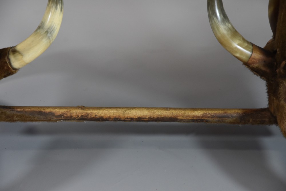 Late nineteenth-century German side table featuring a dark green leather studded top supported by fur-wrapped posts and natural cow horn legs. View VII