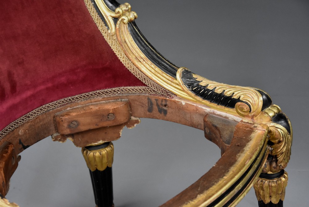 An early 19th-century Regency ebonised and gilt side chair upholstered in crimson velvet with reeded legs and brass castors. View XII