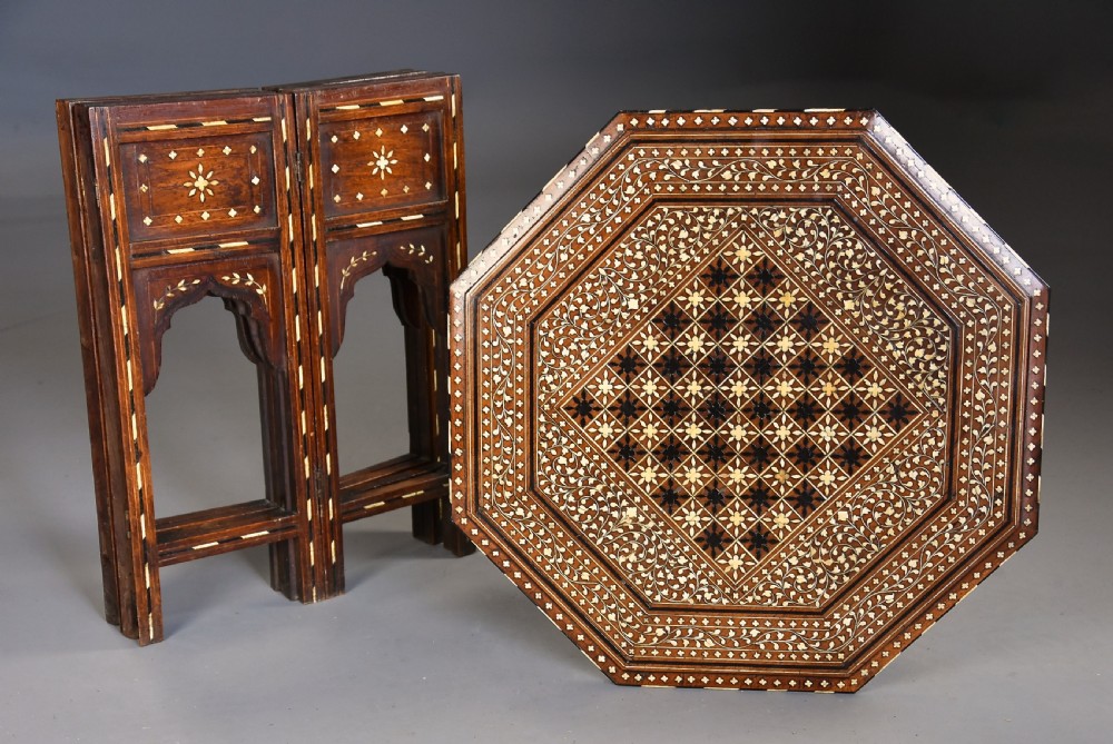 Late 19th-century octagonal Anglo-Indian occasional table crafted from dark wood with extensive geometric bone inlay, a chessboard top design, and arched legs. View X