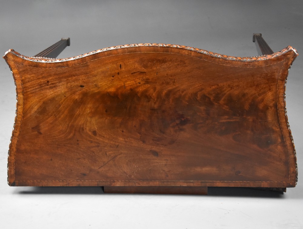 An 18th-century mahogany fold-over card table featuring a serpentine front, carved egg-and-dart rim moulding, and straight fluted legs. View XI