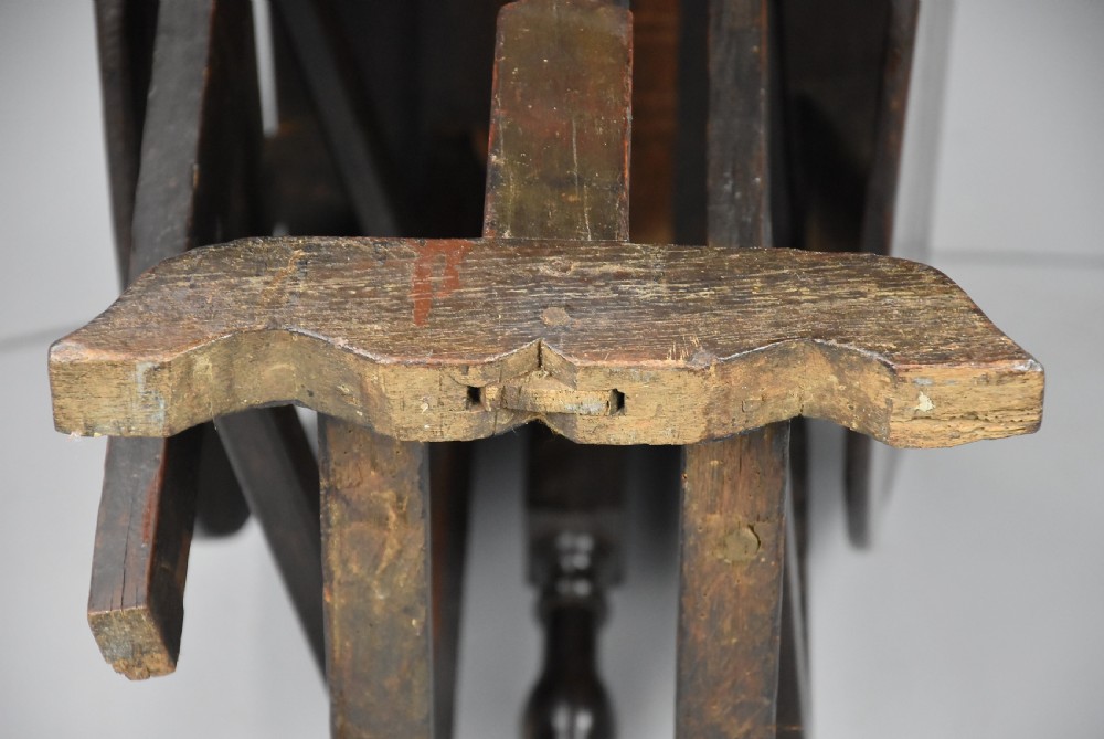 A seventeenth-century dark oak gateleg table shown with both drop-down leaves extended to form an oval tabletop supported on turned legs. View XVI