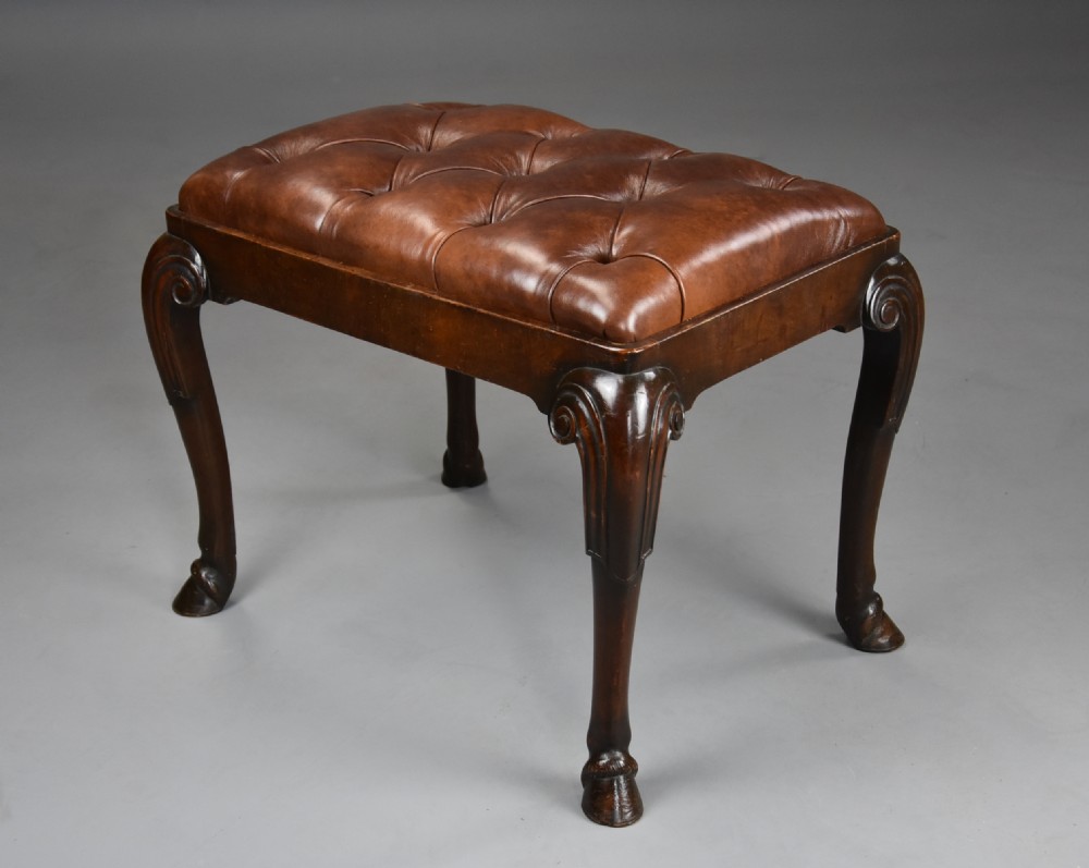 A late 19th-century Queen Anne style walnut stool featuring a deep-buttoned brown leather seat and carved cabriole legs with hoof feet. View III