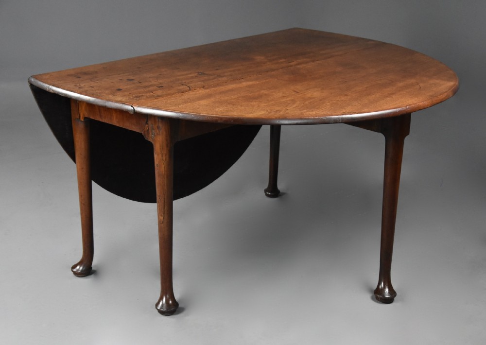 A mid-18th-century solid walnut drop-leaf dining table supported by cabriole legs with pad feet. View IV