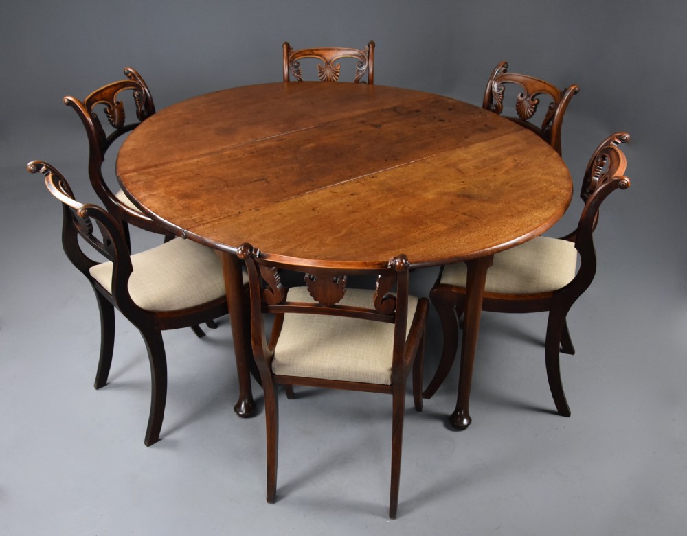 A mid-18th-century solid walnut drop-leaf dining table supported by cabriole legs with pad feet. View IX