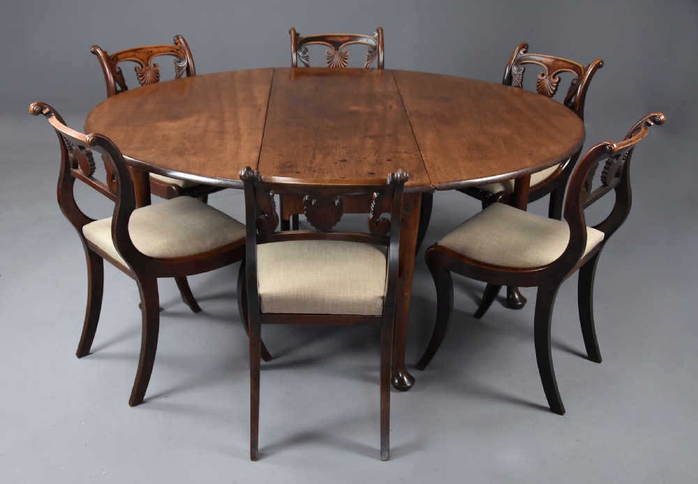 A mid-18th-century solid walnut drop-leaf dining table supported by cabriole legs with pad feet. View X