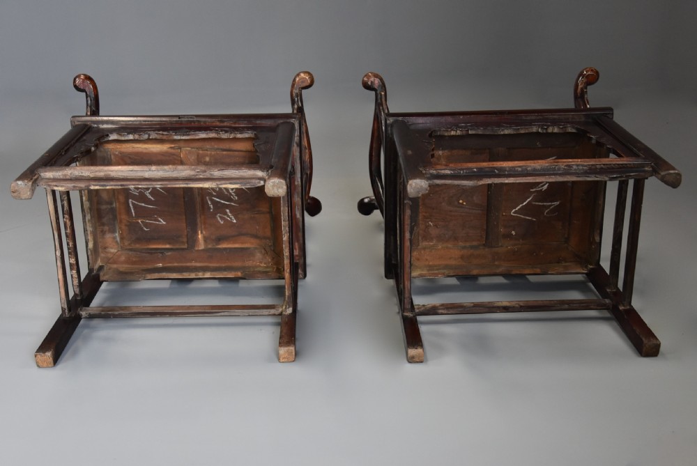 A pair of late 19th-century Chinese armchairs crafted from dark red lacquered elm with shaped yokeback top rails and hand-carved central splats. View XII