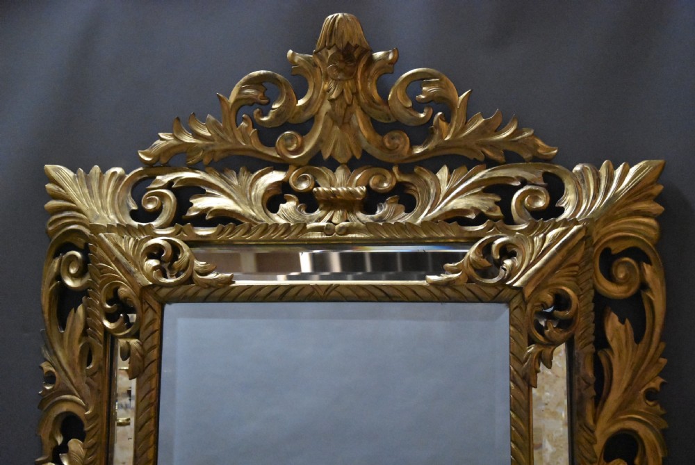 An ornate late 19th-century rectangular Italian giltwood wall mirror featuring a cushion-style frame with secondary glass border panels and carved acanthus leaf scrollwork. View III