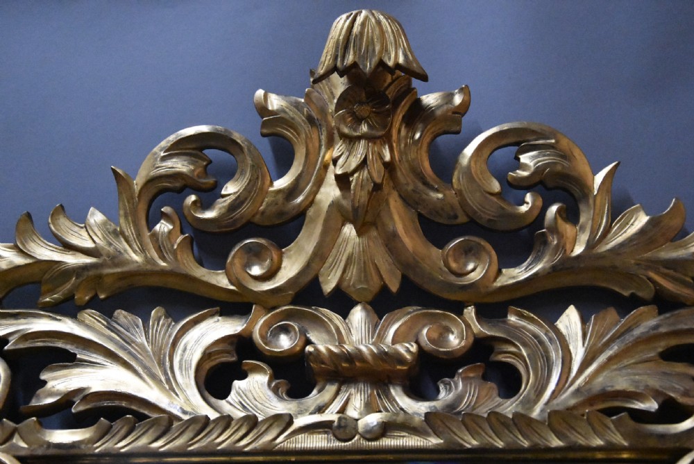 An ornate late 19th-century rectangular Italian giltwood wall mirror featuring a cushion-style frame with secondary glass border panels and carved acanthus leaf scrollwork. View IV