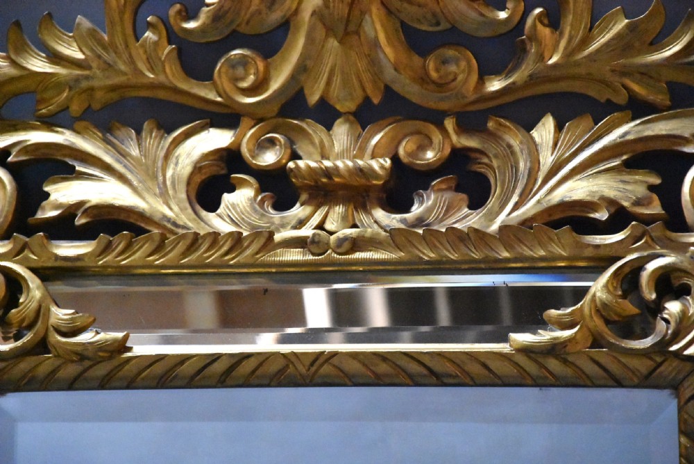 An ornate late 19th-century rectangular Italian giltwood wall mirror featuring a cushion-style frame with secondary glass border panels and carved acanthus leaf scrollwork. View IX