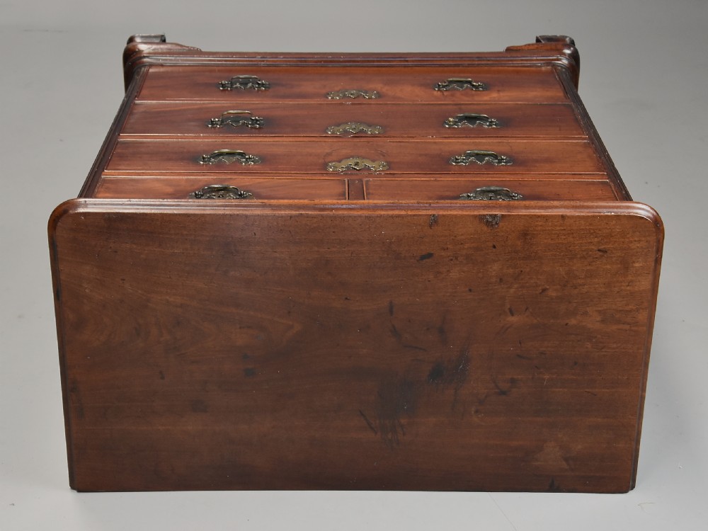 A mid-18th century George III mahogany chest of drawers featuring a two short over three long drawer configuration with brass swan-neck handles and bracket feet. View XI