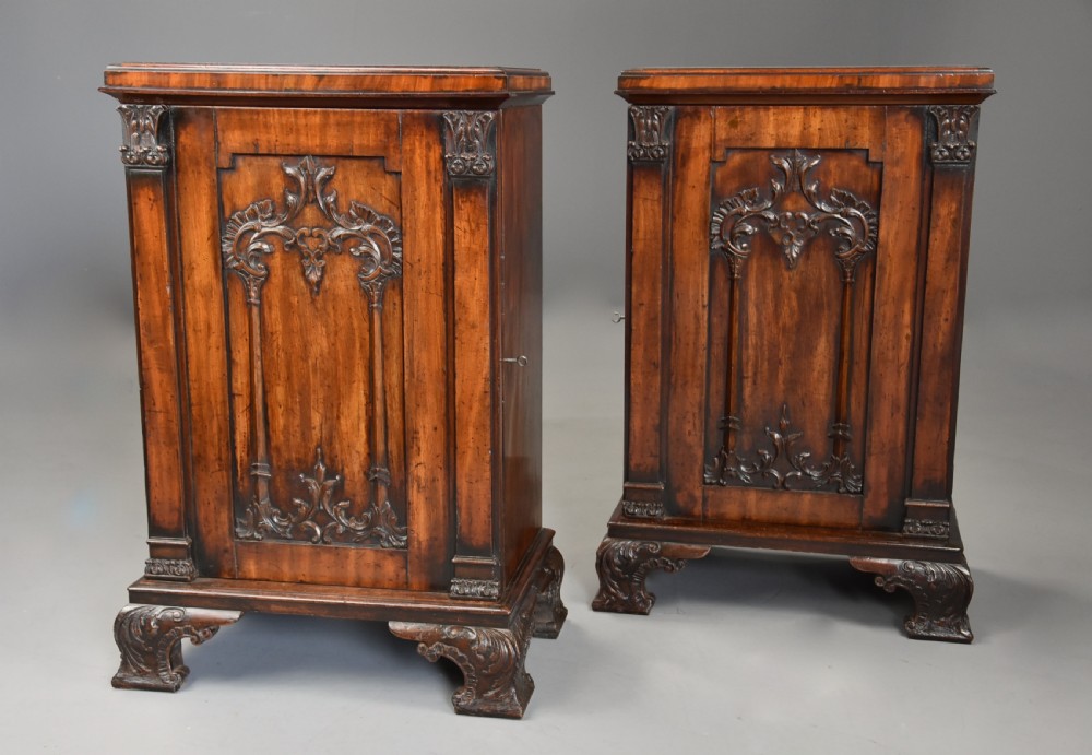 A pair of mid-18th-century mahogany Chippendale pedestal cabinets featuring relief-carved Rococo door panels, corner pilasters, and carved bracket feet. View II