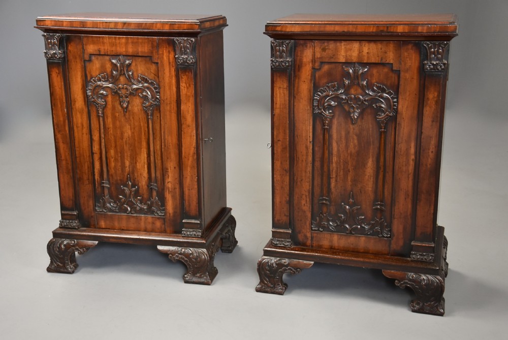 A pair of mid-18th-century mahogany Chippendale pedestal cabinets featuring relief-carved Rococo door panels, corner pilasters, and carved bracket feet. View V