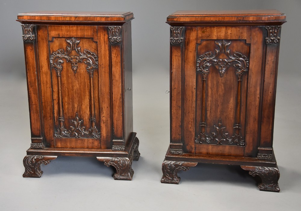 A pair of mid-18th-century mahogany Chippendale pedestal cabinets featuring relief-carved Rococo door panels, corner pilasters, and carved bracket feet. View VI